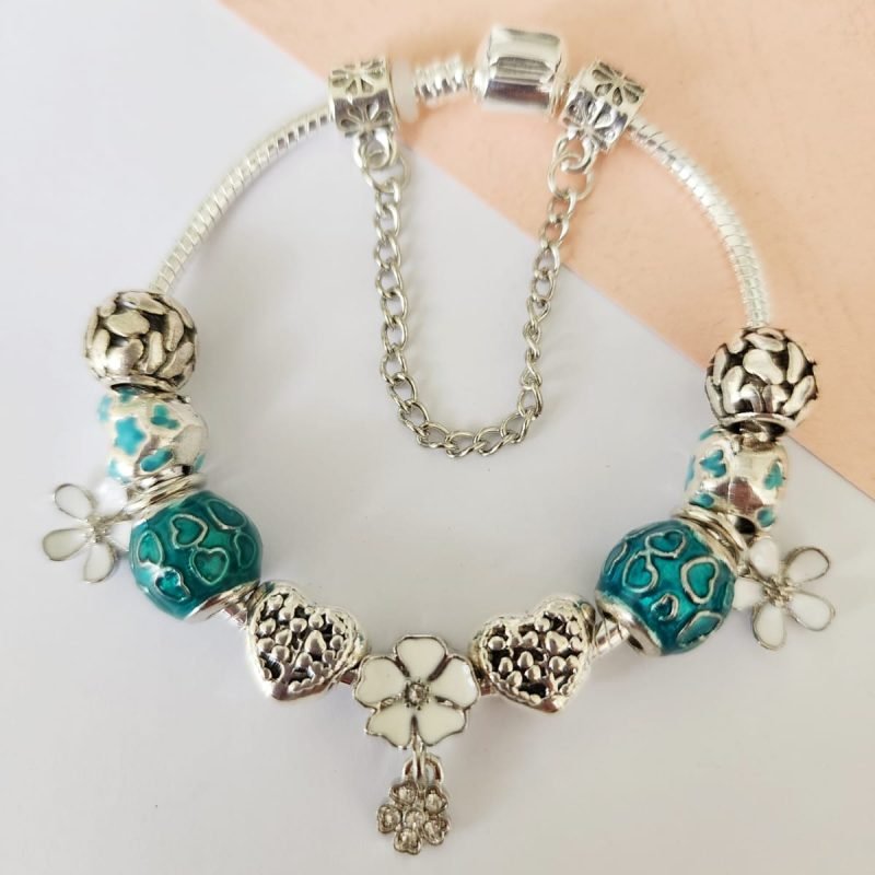 A charm bracelet with white and blue beads